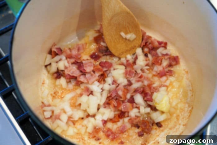Palmetto's Hidden Heart 3 Crispy bacon and diced onions caramelizing in a pan, forming the base of the swamp cabbage recipe.
