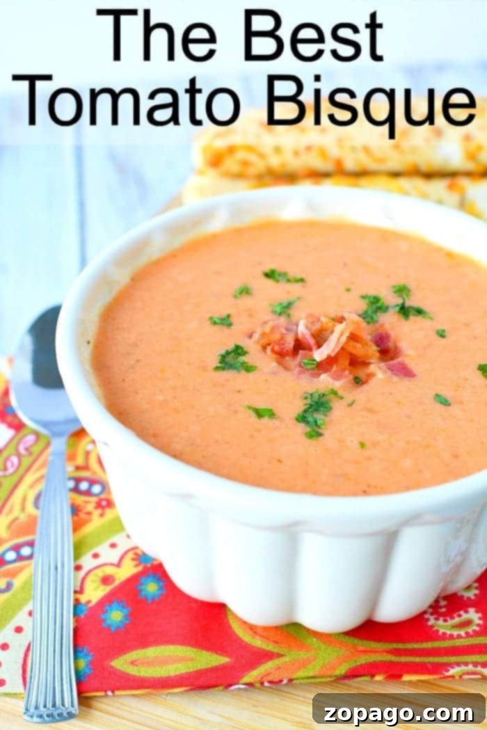 Easy Homemade Tomato Bisque: A Creamy Family Favorite from Canned Tomatoes A steaming bowl of creamy tomato bisque, garnished with fresh herbs, ready to be served.