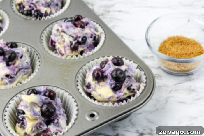 A tray of freshly baked homemade muffins, golden brown and puffed, cooling on a wire rack.
