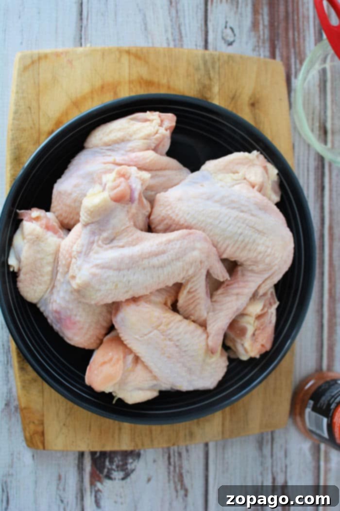 Crispy Air Fryer Whole Chicken Wings 3 Close-up of perfectly cooked whole chicken wings, golden brown and crispy, with a rich seasoning visible.