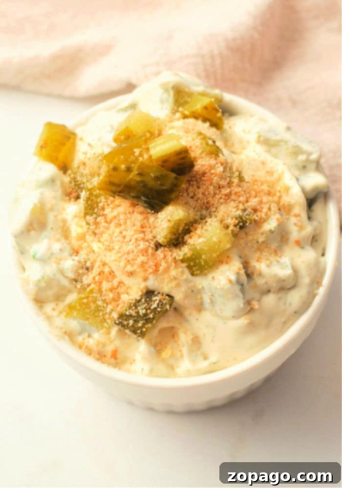 Dill-icious Fried Pickle Ranch Dip 5 A large bowl of ranch pickle dip with fresh dill and pickle slices, perfect for a party spread.