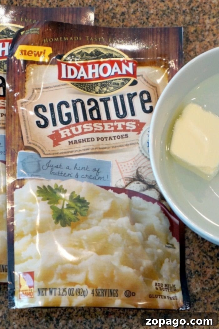 Easy Shepherd's Pie with Instant Mash 3 A bag of Idahoan Signature Russets mashed potatoes next to a bowl of prepared mashed potatoes with a pat of melting butter, ready for Shepherd's Pie.
