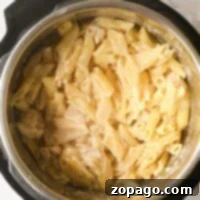 Creamy penne pasta in a pot, with tender frozen chicken simmered to perfection, freshly cooked and ready to serve.