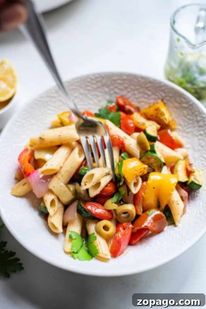 Perfect Air Fryer Mediterranean Roasted Vegetables 7 A large serving bowl filled with perfectly roasted Mediterranean vegetables, garnished with fresh herbs, ready to be enjoyed as a healthy meal.