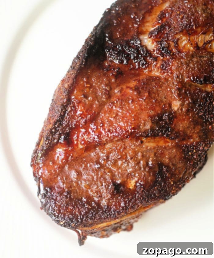 Delicious Ninja Foodi Pork Creations 2 Close-up of a perfectly tender air fryer pork roast, golden brown and ready to serve.