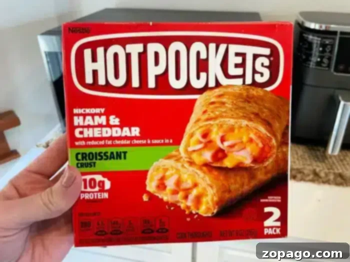 No More Cold Spots Hot Pocket Cook Time Secrets 4 A person is holding a box of Hot Pockets.