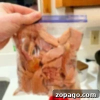 Ziplock bag filled with slices of cooked ham for delicious crockpot recipes.