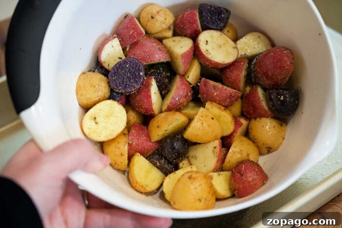 Garlic Butter Shrimp with Crispy Roasted Potatoes 4 A bowl of seasoned, chopped red, yellow, and purple potatoes is ready for roasting—perfect to pair with shrimp and potatoes for a hearty meal.