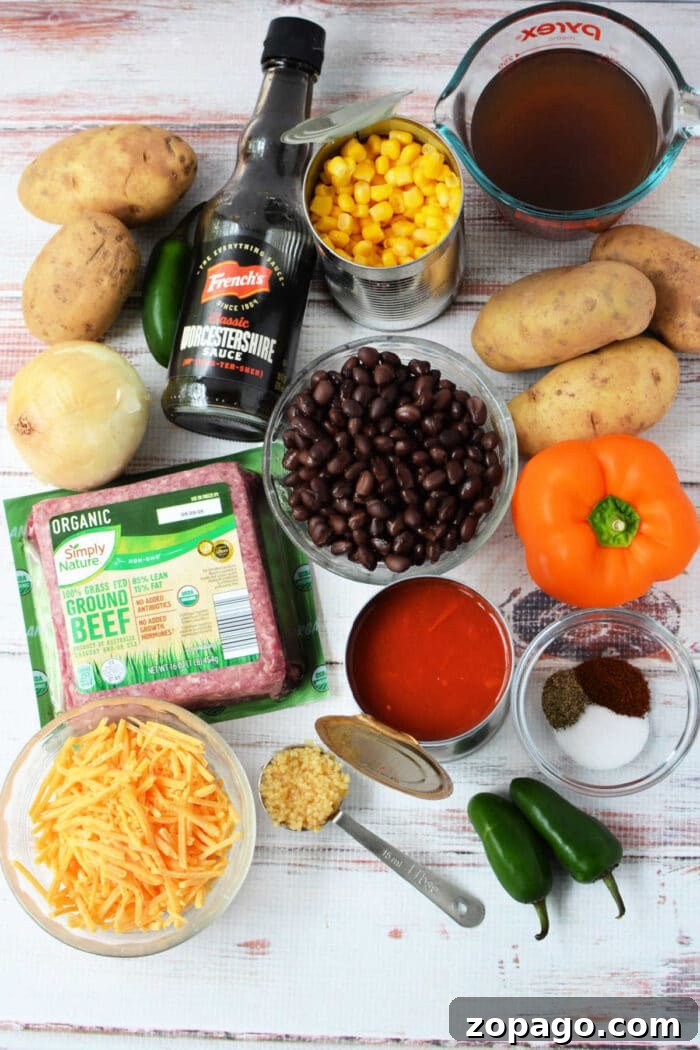 Slow Cooker Cowboy Casserole 3 Ingredients for a Cowboy Casserole: potatoes, corn, black beans, cheese, beef, jalapeños, onion, spices, broth, and sauce—perfect for an easy Crockpot Tex-Mex meal.