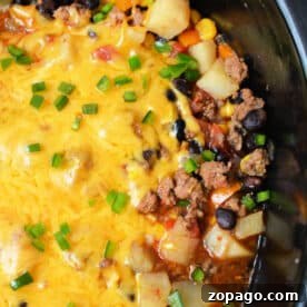 Enjoy this hearty Cowboy Casserole Crockpot dish—cheesy ground beef, potatoes, black beans, corn, and green onions all slow-cooked to perfection.